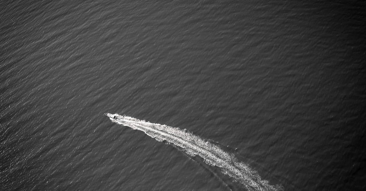 Why are cruise ships on a 14 day schedule? [closed] - Black and white of motorboat sailing on fast speed in open sea in sunny day