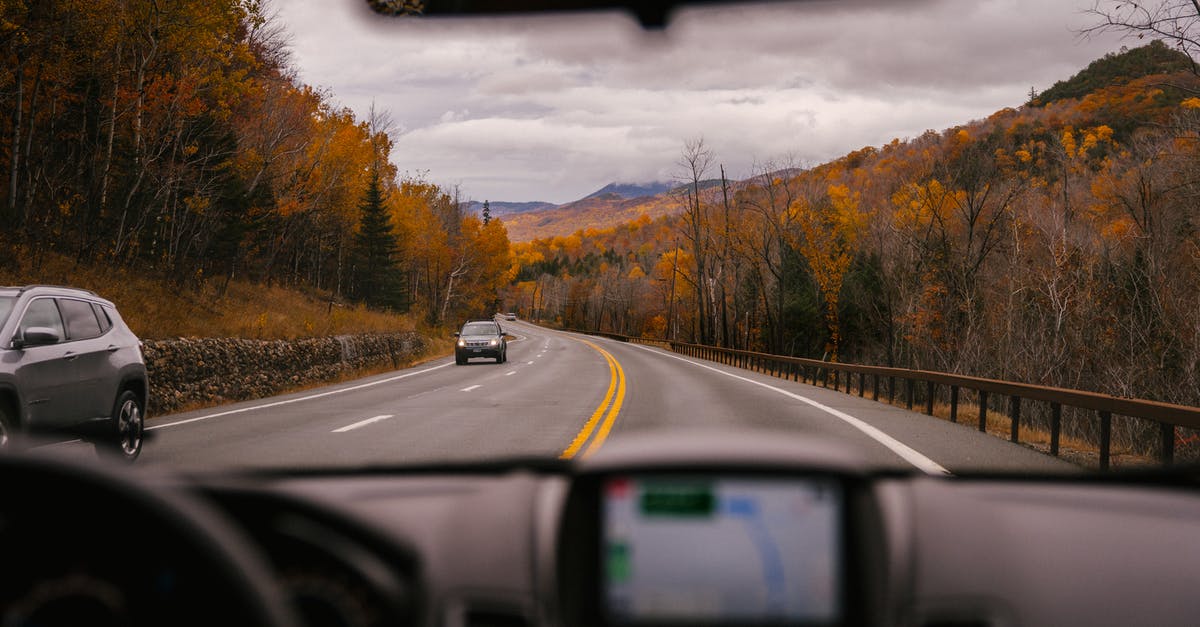 Why are round-trip car rentals much cheaper than one-way car rentals? - Car riding on highway through autumn forest