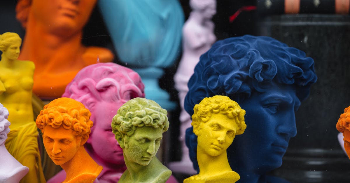 Why are so many airline check-in counters idle so often? - Collection of colorful head sculptures of David in different colors and shapes placed on counter in store with decorative souvenirs