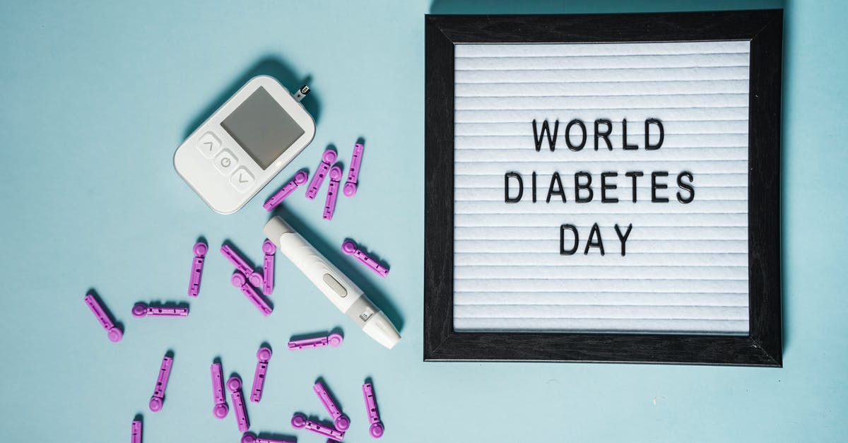 Why are so many electronic passport gates kept closed? - Top view of lancets for blood glucose meter placed near glucometer and letter board with World Diabetes Day inscription