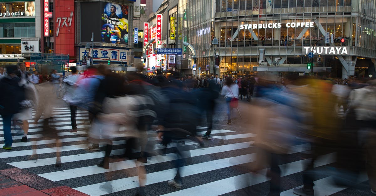 Why are some pedestrian traffic lights covered in shades in London? - People Crossing the Street in Japan