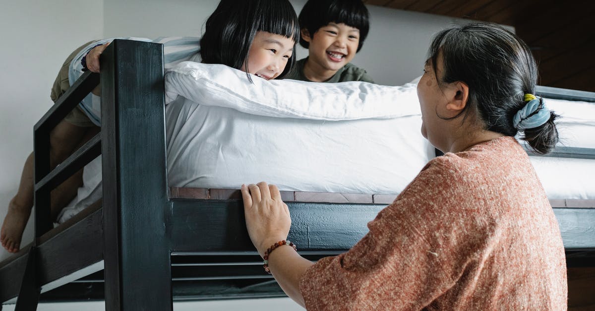 Why are there no 2,3,4,5 tier bunk beds on airplanes? - Grandmother near bunk bed with Asian kids