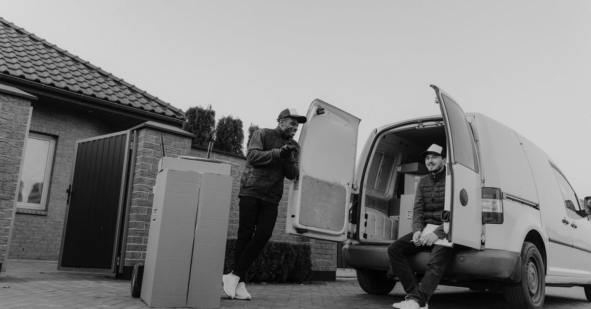 Why are there no courier services or box-rentals near airport security? - Grayscale Photo of Man in Jacket Standing Beside Van Why are there no courier services or box-rentals near airport security? - Grayscale Photo of Man in Jacket Standing Beside Van