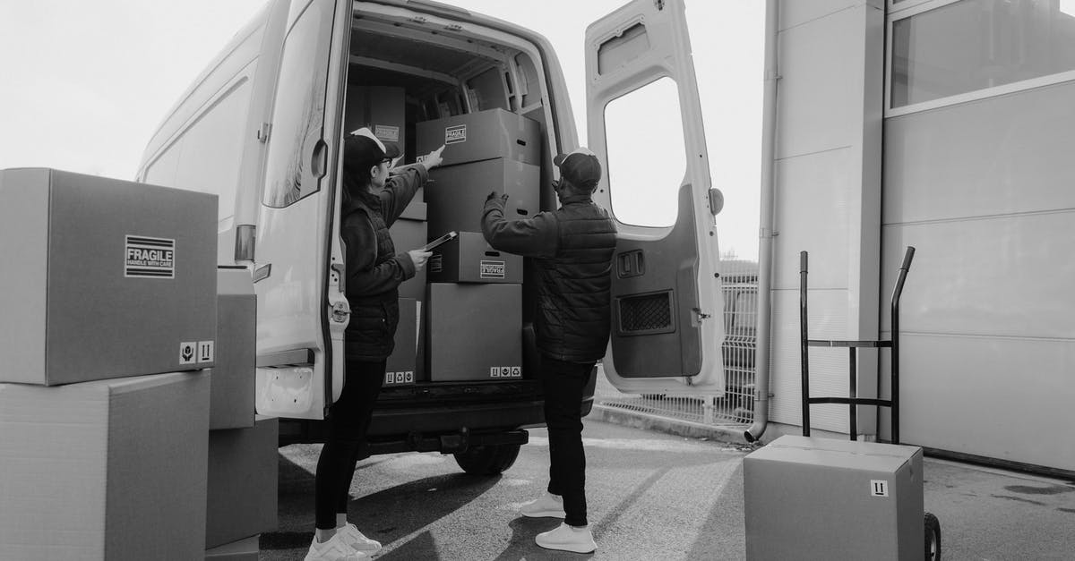 Why are there no courier services or box-rentals near airport security? - Man in Black Jacket and Pants Standing in Front of Man in Black Jacket in Grayscale Why are there no courier services or box-rentals near airport security? - Man in Black Jacket and Pants Standing in Front of Man in Black Jacket in Grayscale