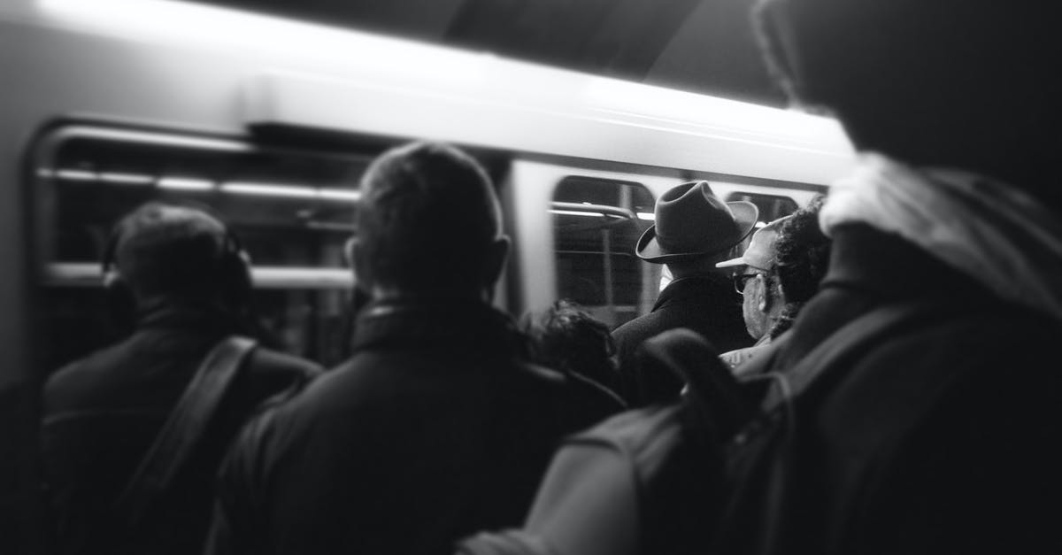 Why are there no waste bins on public transport? [closed] - Grayscale Photography of People Standing Near Train