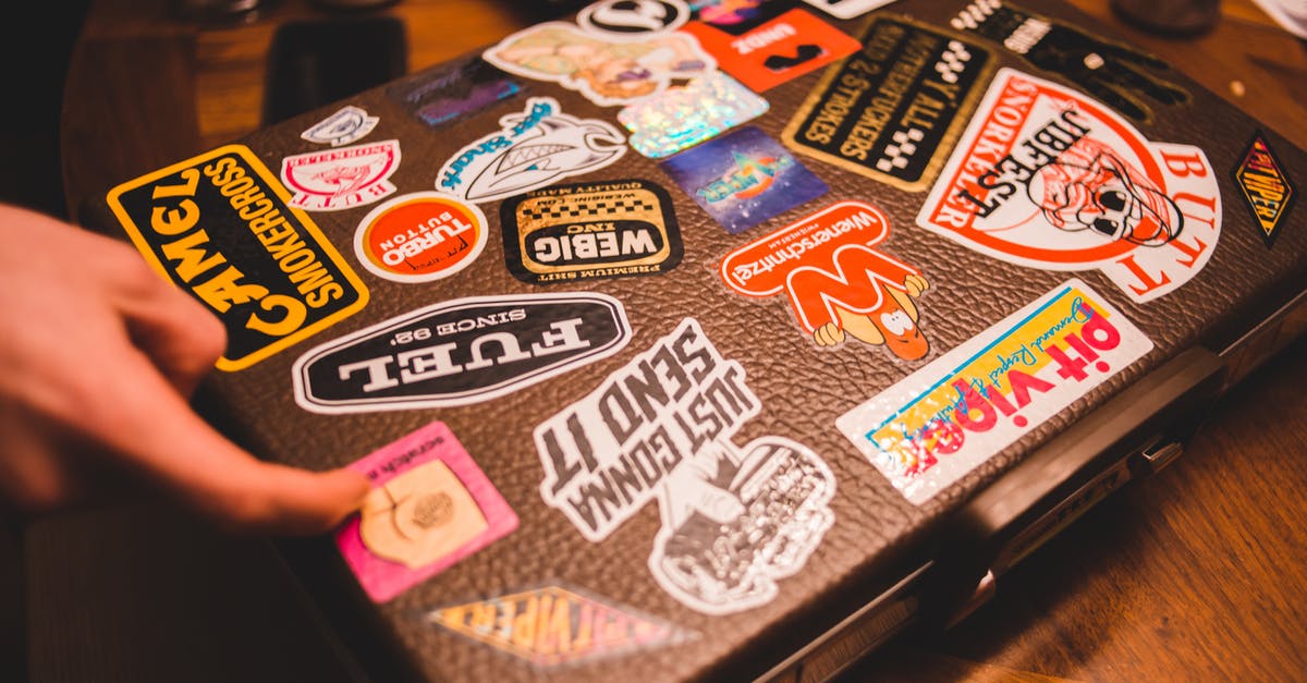 Why aren't there cube-shaped suitcases or bags? - Black suitcase with stickers placed on table