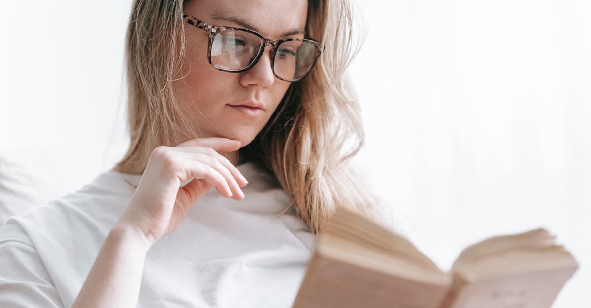 Why booking services never consider MIA for transfers? - Low angle of crop concentrated female in eyeglasses touching chin while reading novel at free time