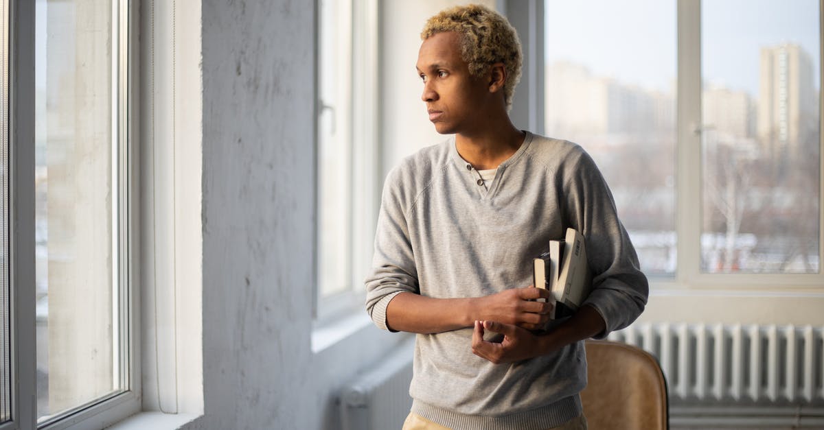 Why booking services never consider MIA for transfers? - Thoughtful African American male in casual outfit with books looking away near windows in university