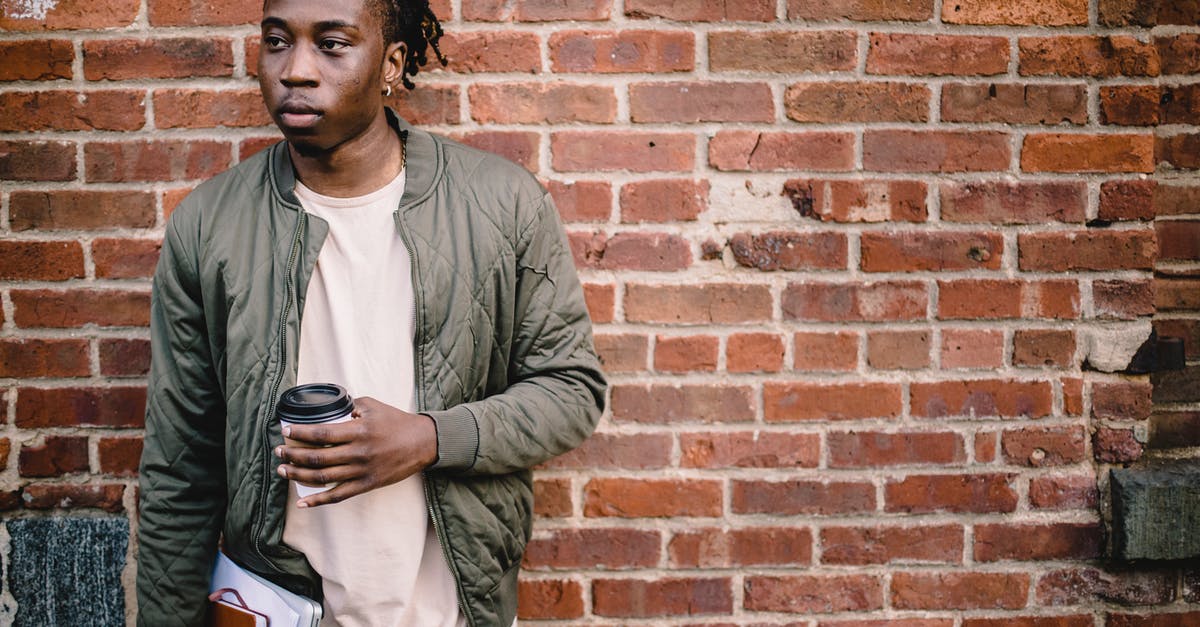 Why can't I book this multi-city fare on American Airlines? - Pensive young man with coffee and notebooks standing near wall