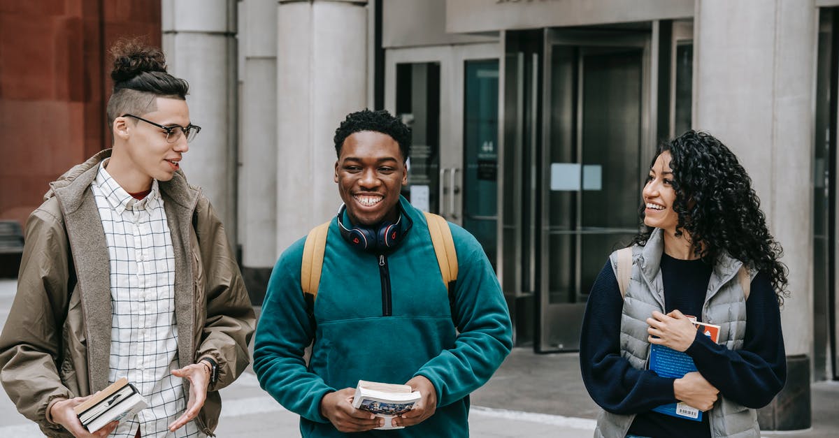 Why can't I book this multi-city fare on American Airlines? - Group of smiling multiracial students with books strolling near building