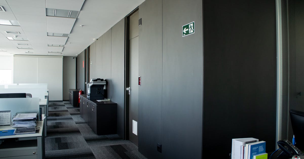 Why did a gate officer and exit immigration officer try to peel my visa sticker? - Modern workplace interior with tables and carpeting floor Why did a gate officer and exit immigration officer try to peel my visa sticker? - Modern workplace interior with tables and carpeting floor