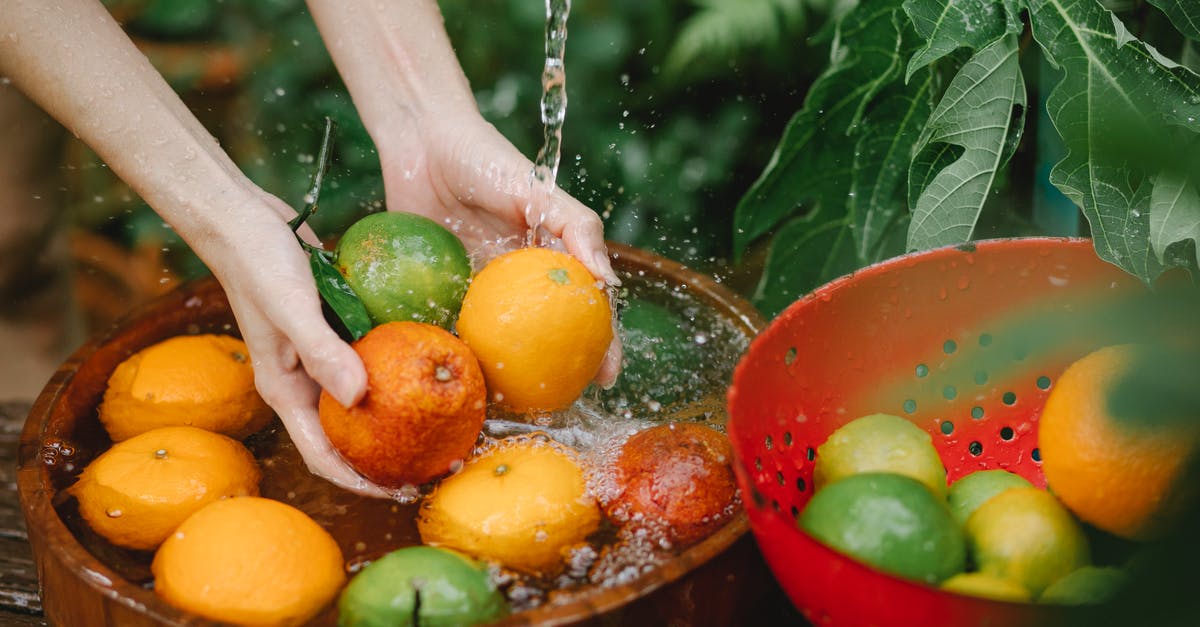 Why did airport security swab my hands with wet paper? - Woman washing fresh fruits in tropical orchard