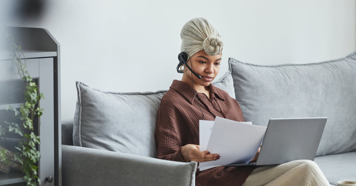 Why didn't the check-in agent recognize my long term visa? - Focused black woman with laptop examining documents