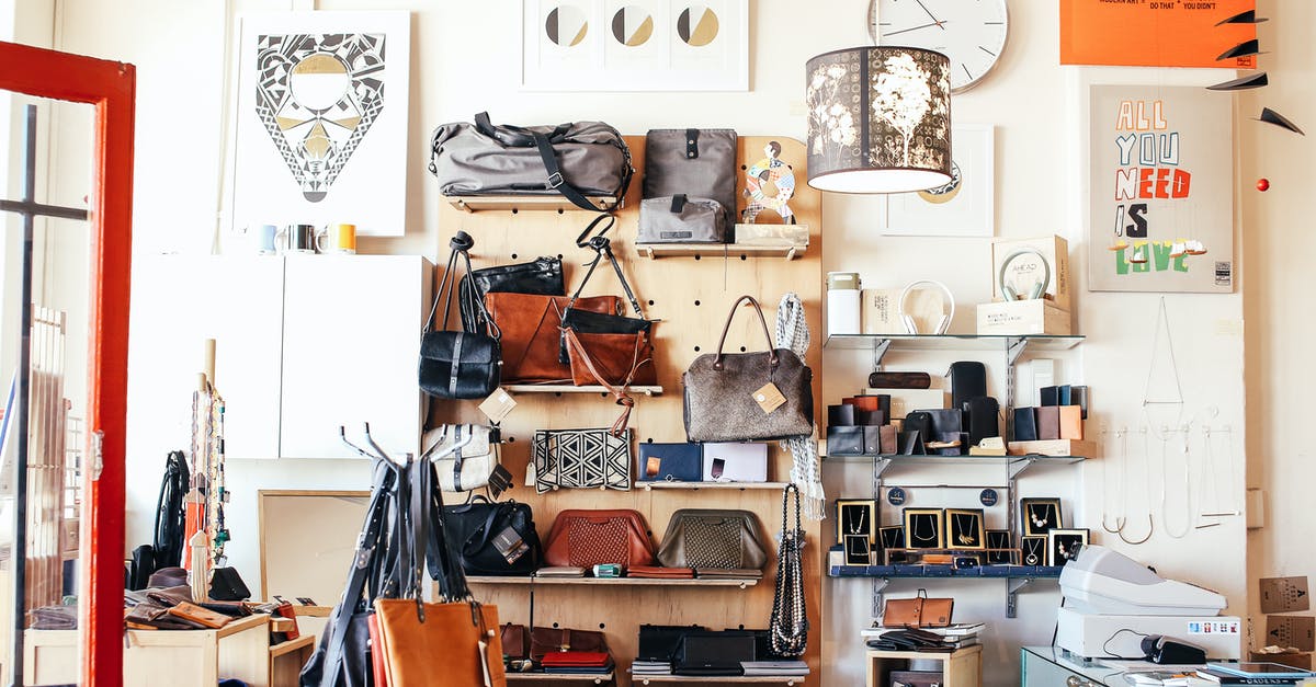 Why do many airports offer bag wrapping services? - Assorted purses on shelves in shop