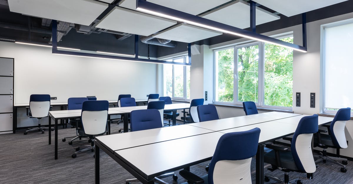 Why do many public bathrooms in Israel lack toilet seats? - Contemporary office with chairs at desks