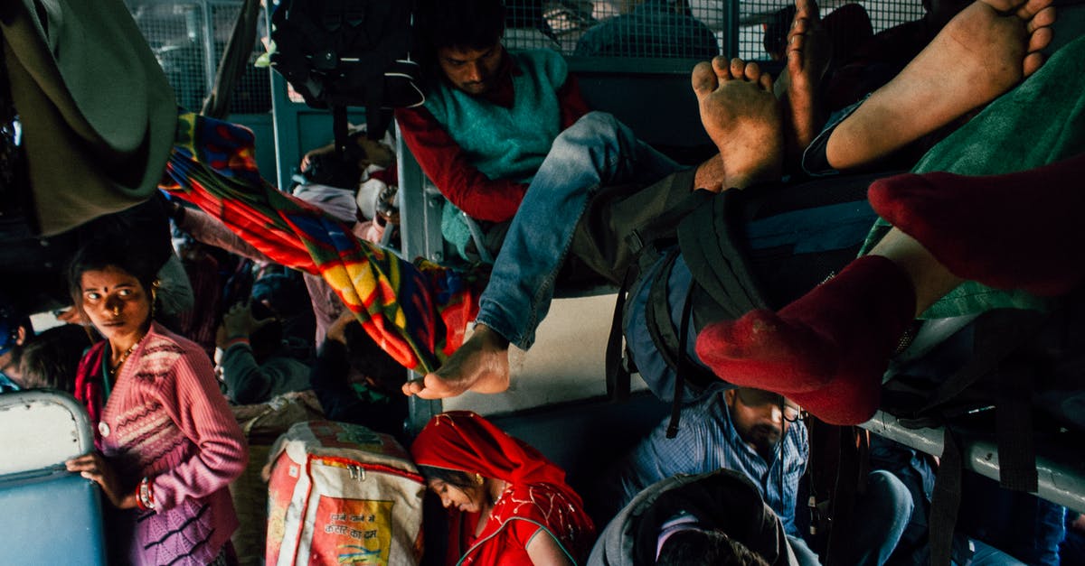 Why do people crowd baggage carousels? [closed] - Poor people with many backpacks and bags in old crowded bus having trip during holiday