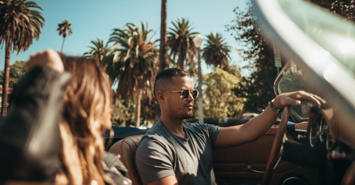 Why do rental car companies hand you two keys wired together? - Man and Woman Riding Convertible Car