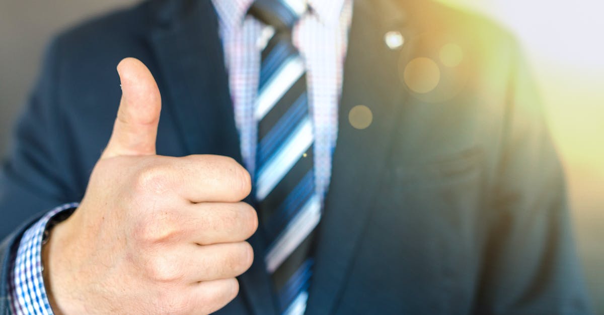 Why do the Japanese wear masks like Surgeons in Tokyo? [closed] - Close-up Photo of Man Wearing Black Suit Jacket Doing Thumbs Up Gesture