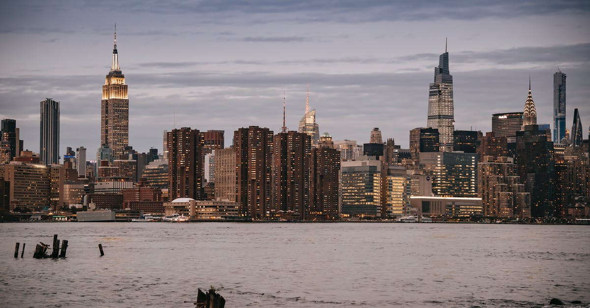 Why do US officers sometimes stamp non-US passports? [duplicate] - Modern architecture with towers and skyscrapers with luminous lights in windows on river bank in NYC