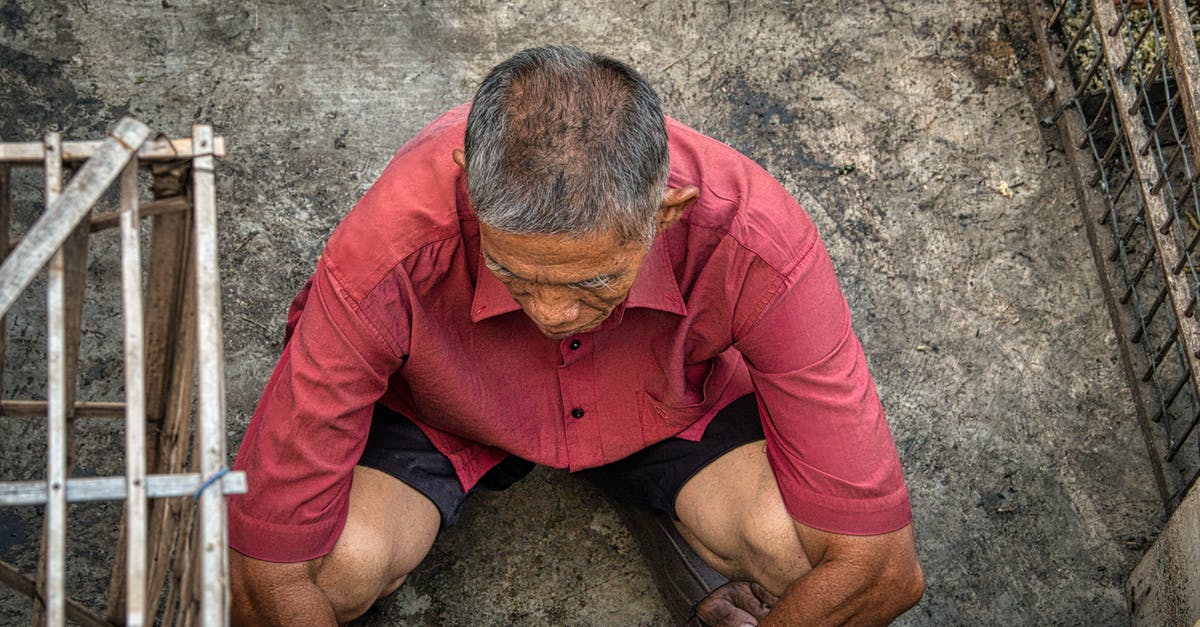 Why does a flight from Melbourne to Cape Town need to go via Doha? - From above of anonymous ethnic male squatting on dirty floor near grid on street in poor district of rural area Why does a flight from Melbourne to Cape Town need to go via Doha? - From above of anonymous ethnic male squatting on dirty floor near grid on street in poor district of rural area