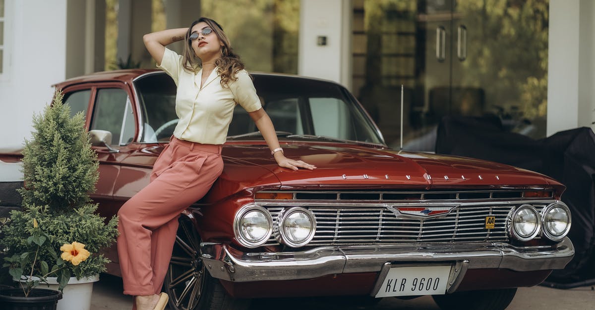 Why does Rotterdam not want me to lean against buildings? - Blond Woman Leaning against Red Vintage Car