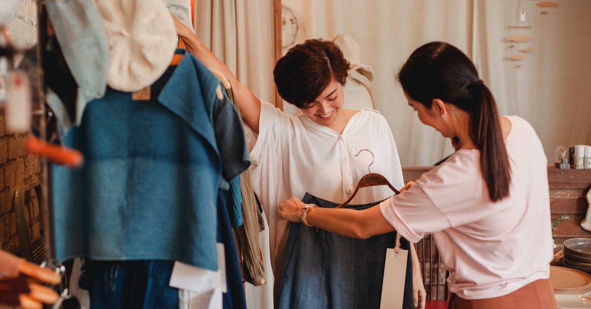 Why does the Eurostar not show youth pricing? - Unrecognizable woman showing clothes to cheerful Asian girlfriend in shop