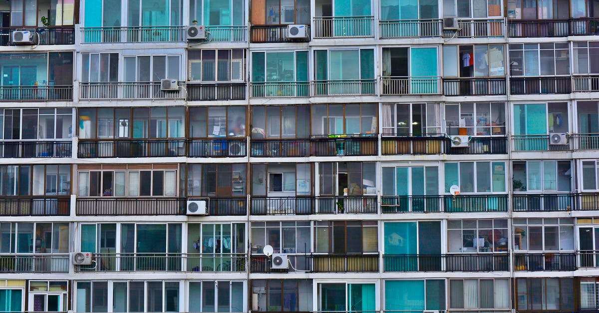 Why don't hotels mount air conditioning units outside the rooms? [closed] - Facade of contemporary residential multistage house with many apartments representing fenced terraces and windows near outdoor air conditioning units in town in daylight