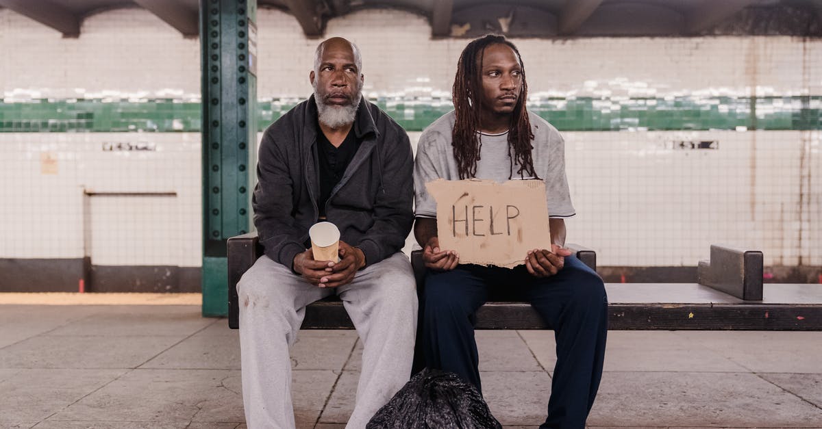 Why is homelessness not an issue in Tokyo? [closed] - Man and Woman Sitting on Bench