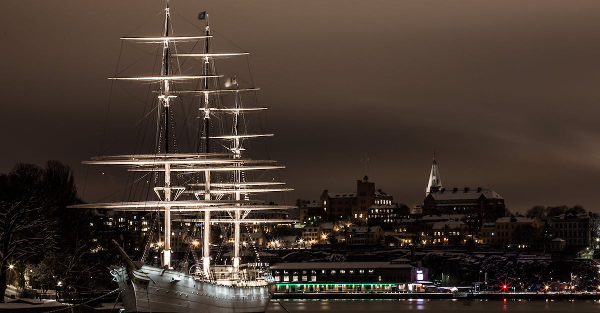 Why is Nynäshamn a de facto "port" for Stockholm? - White Ship on Port at Night