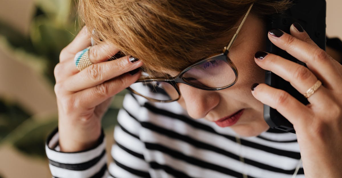 Why is using plugs so difficult in Vietnam? - Anxious woman having phone conversation in office