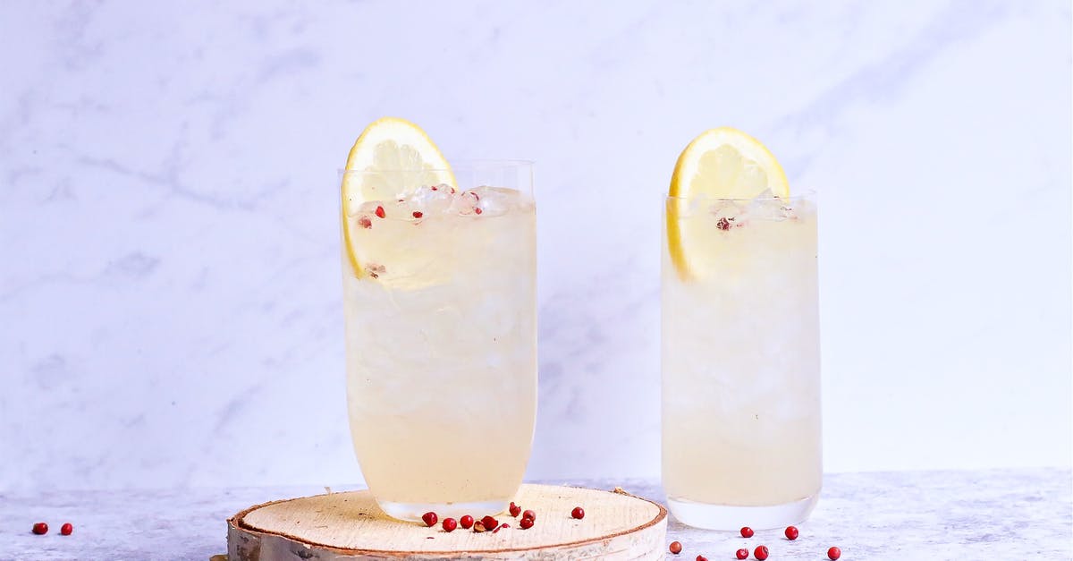 Why was I served an ice cold towel onboard? - Glasses of delicious cold lemonade decorated with lemon slice and berries on wooden board in light studio