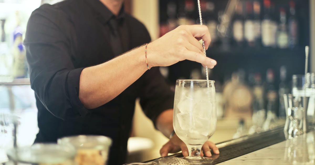 Why was I served an ice cold towel onboard? - Crop barman making cocktail in pub