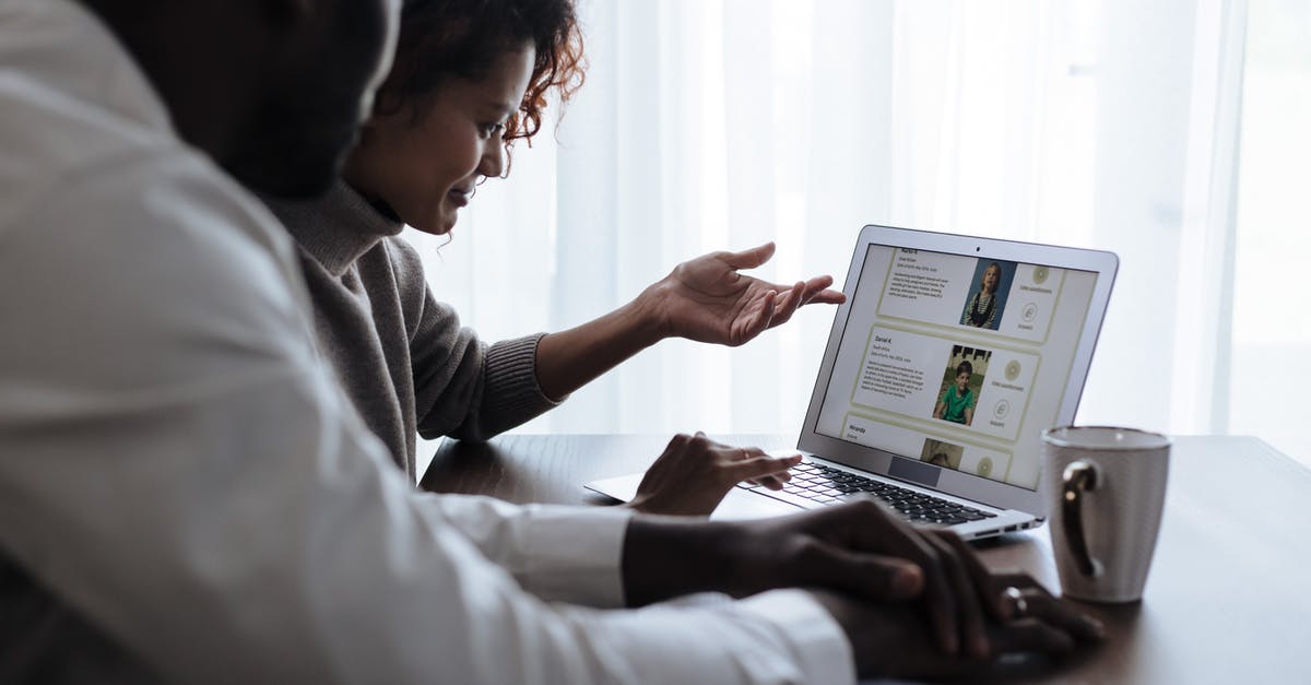 Wife applying for UK visa after husband got the decision? - Couple at Home Sitting at Table and Looking at Laptop Screen