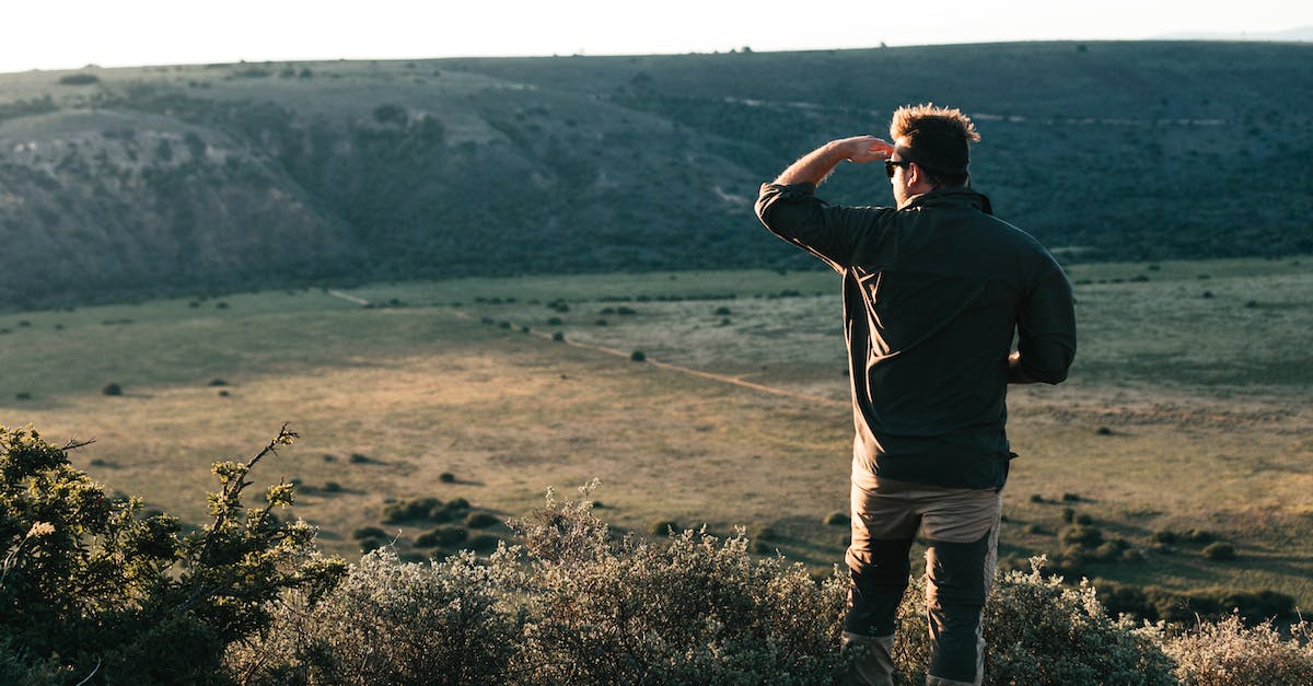 WildLife Tourist Destination in France - Unrecognizable traveler standing on hilltop in daytime