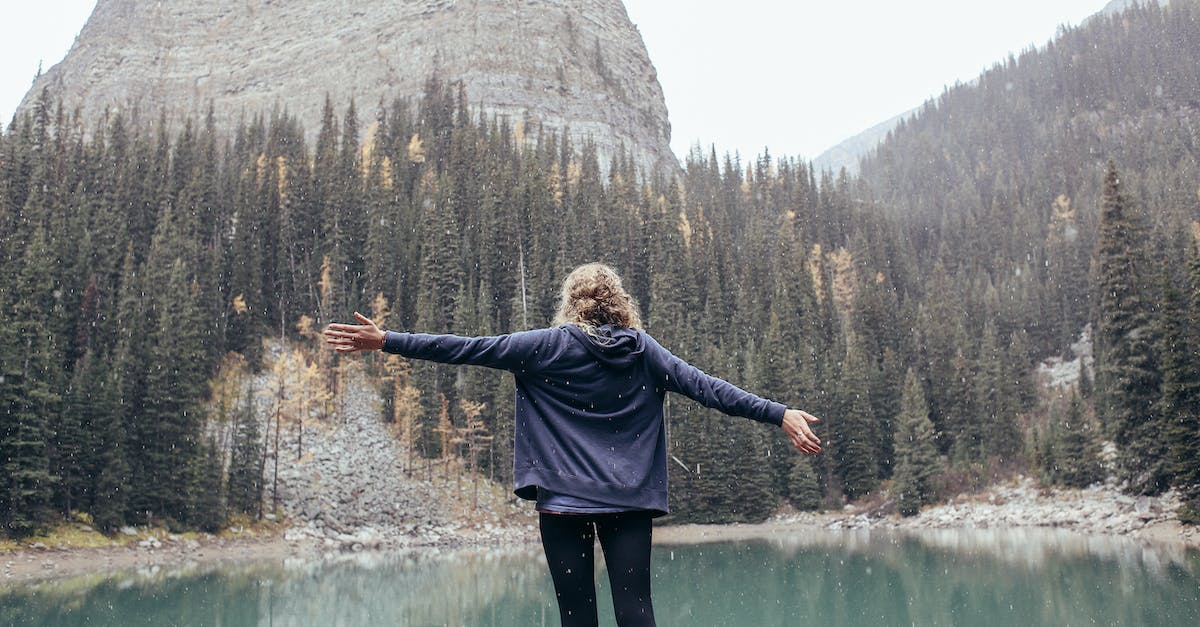 WildLife Tourist Destination in France - Woman with arms outstretched standing on coast of lake