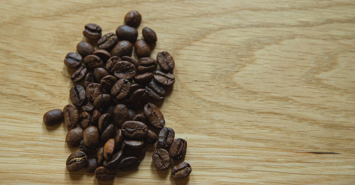 Will Brexit make a difference to my EU/UK NHIC? [closed] - Top view of scattered coffee beans placed on wooden table before making coffee