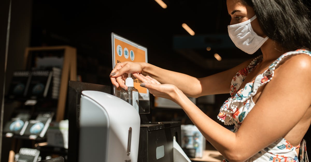 Will confiscation of over-the-limit alcohol prevent someone travelling to Cuba? [closed] - Close-Up Shot of a Woman Sanitizing Her Hand With Alcohol