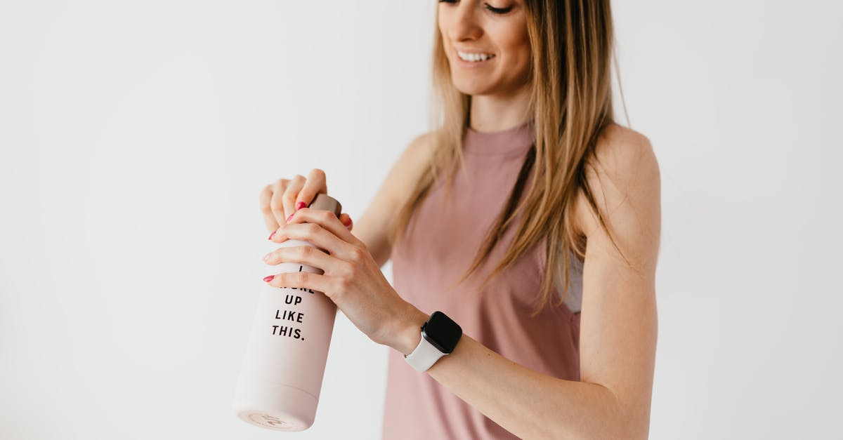 Will I fit or need an extension?(first time flyer) [duplicate] - Crop cheerful young female in casual clothes with smart watch on wrist opening bottle on white background