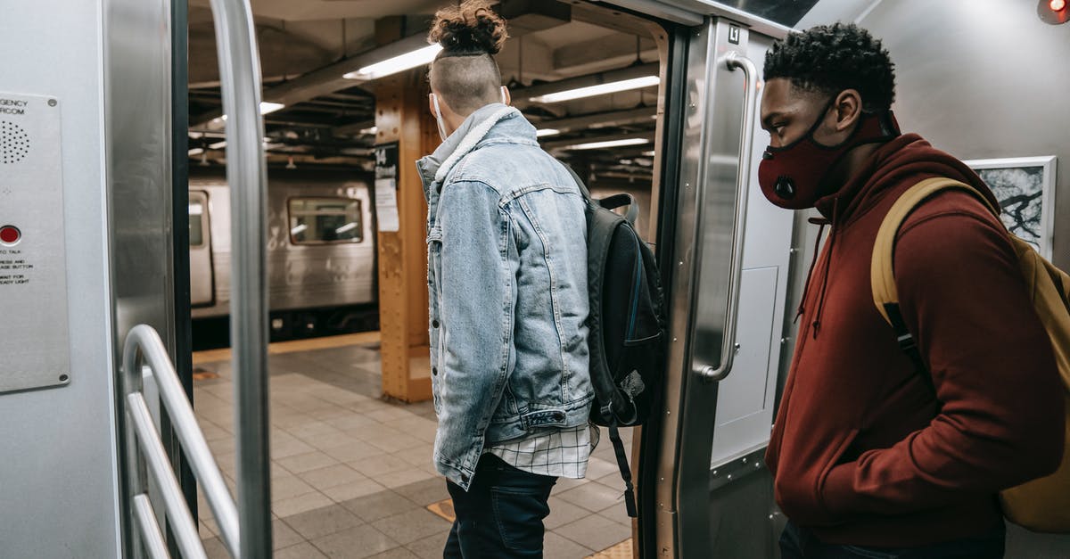 Will I get refund if train was cancelled - Anonymous diverse passengers with rucksacks getting off subway