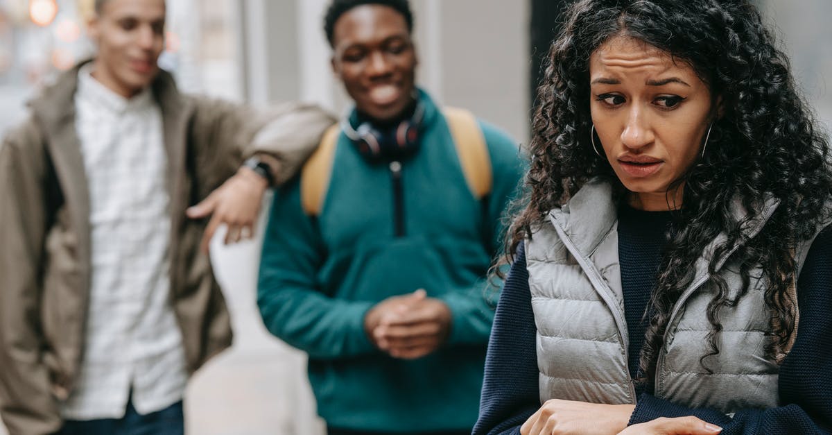 Will I have trouble getting a B1/B2 visa after overstaying my ESTA by 1 day? - Laughing multiracial teenage boys mocking at depressed young ethnic female standing on street after school