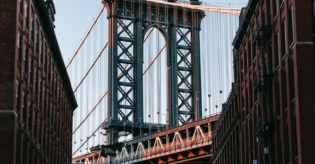 Will I need to clear US customs twice? [duplicate] - From below of bridge with metal heavy arch near concrete buildings under cloudless blue sky