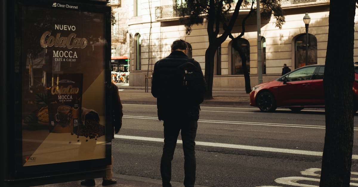 Will IRCTC refund after cancelling waiting list ticket? - Man in Black Jacket Walking on Sidewalk