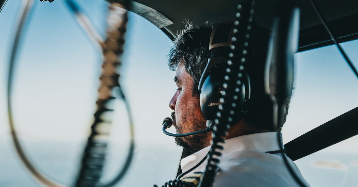 Will my aircraft have single or double prong headphone connection? - Photo of Man Flying a Helicopter