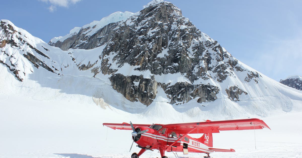 Will my checked luggage freeze in the airplane? - Red Monoplane in Alps