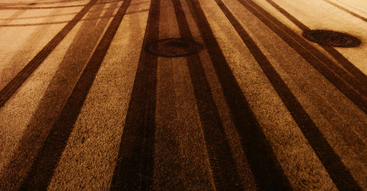 Will nights be cold along the route from Perth to Melbourne at the end of November? - From above of manholes on snowy asphalt road with tire tracks in winter evening Will nights be cold along the route from Perth to Melbourne at the end of November? - From above of manholes on snowy asphalt road with tire tracks in winter evening