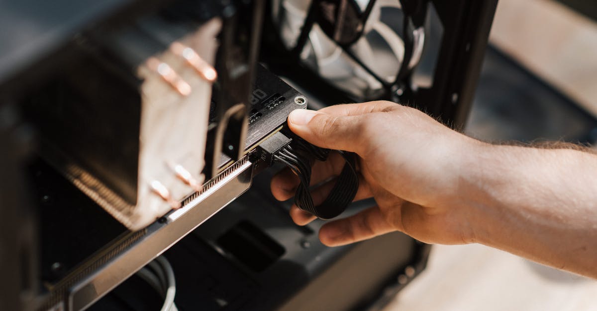 Will this device work with a US/Europe adapter? - Crop faceless man inputting cables in system unit