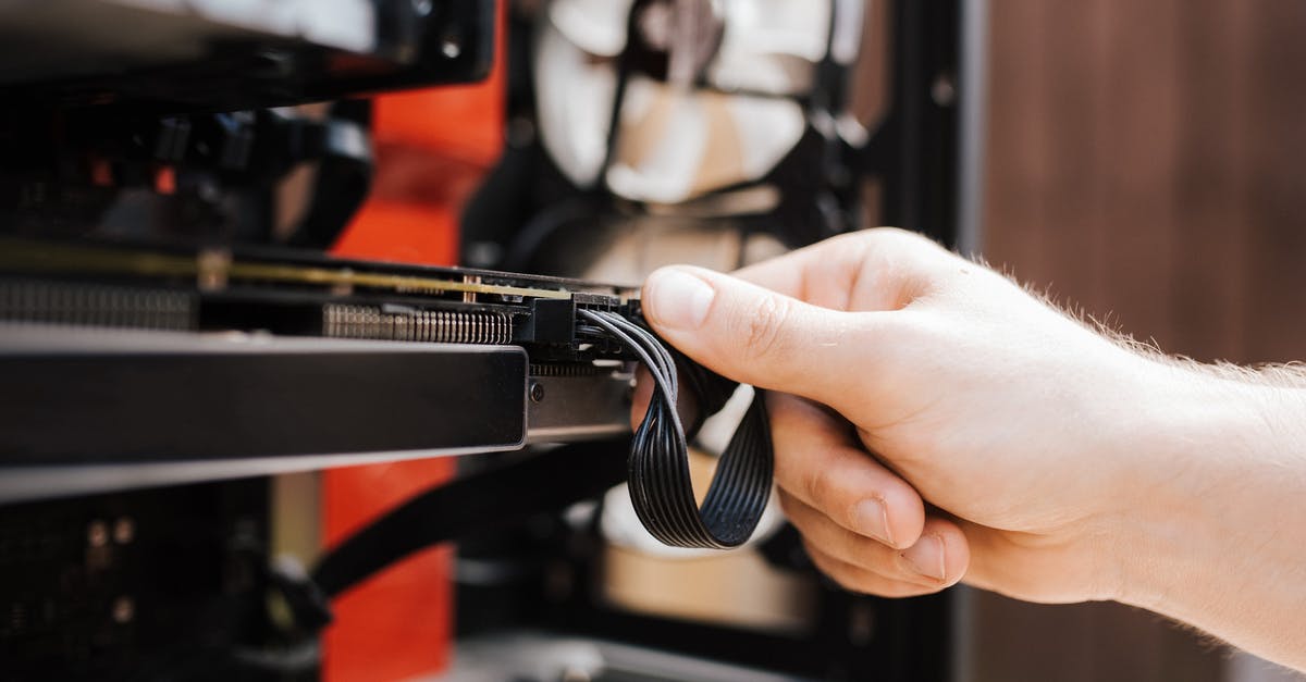 Will this device work with a US/Europe adapter? - Crop faceless man fixing cables in system unit