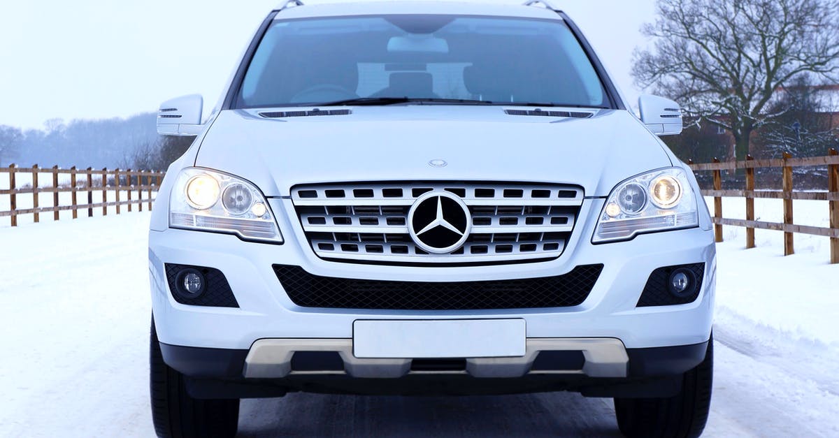 Winter / snow tires in Denmark for March - White Mercedes Benz Car on White Snow Covered Ground at Daytime