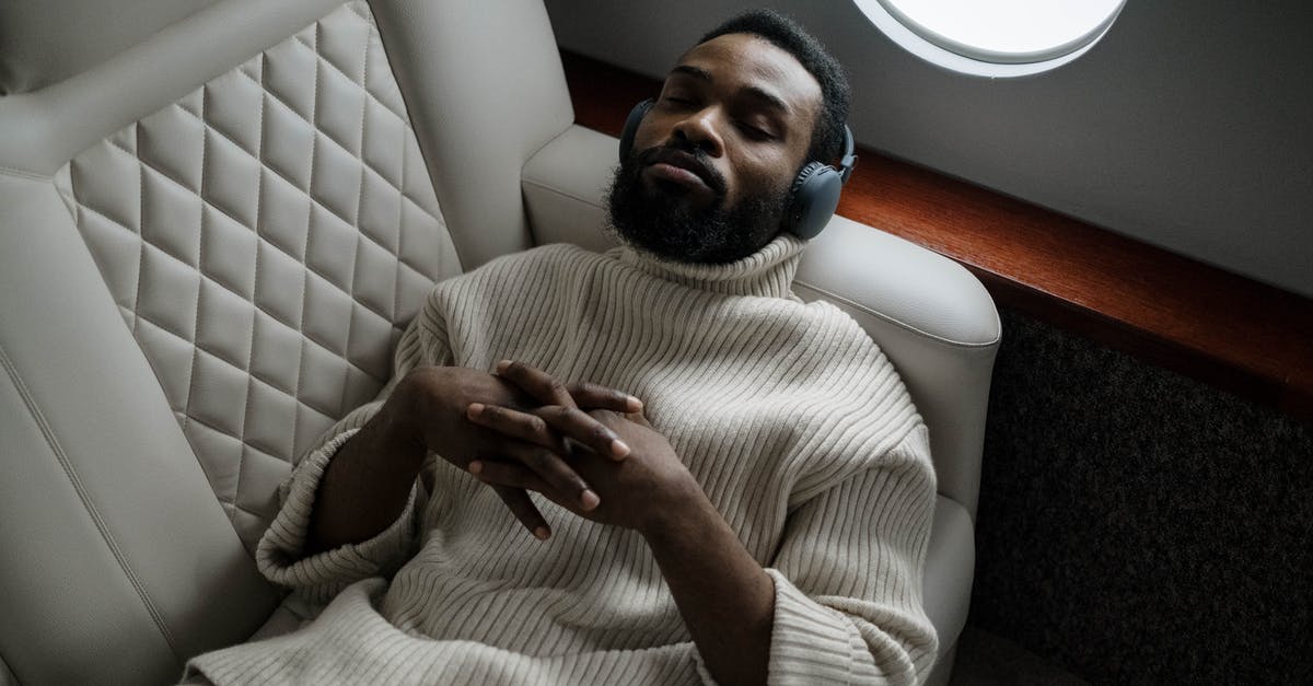 Wireless router a on plane - Man in White Long Sleeve Shirt Sitting on White Chair