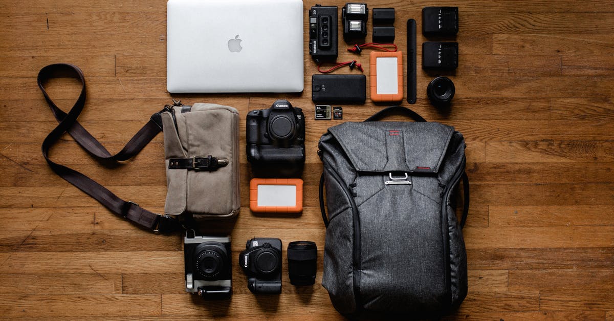 Wireless router in checked or carry-on luggage - Top View Photo Gadgets on Hardwood Floor